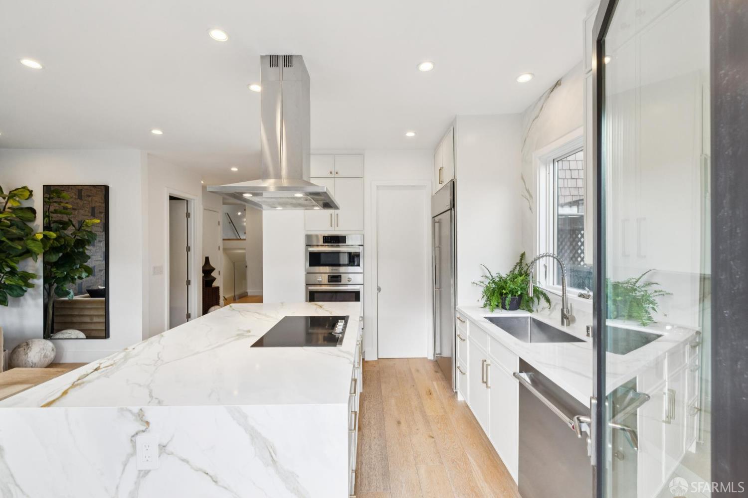 439 Clipper Street San Francisco, CA 94114 - Photo 17 of 71 a kitchen with stainless steel appliances kitchen island granite countertop a refrigerator a oven a sink and a potted plant
