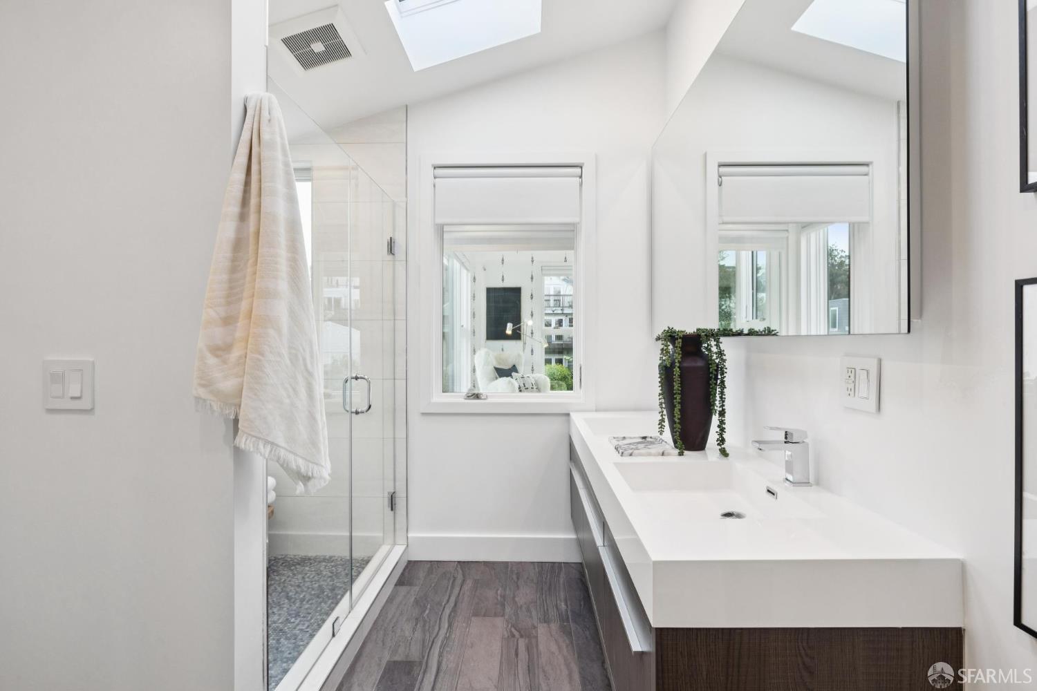 439 Clipper Street San Francisco, CA 94114 - Photo 39 of 71 a bathroom with a sink a mirror and a shower