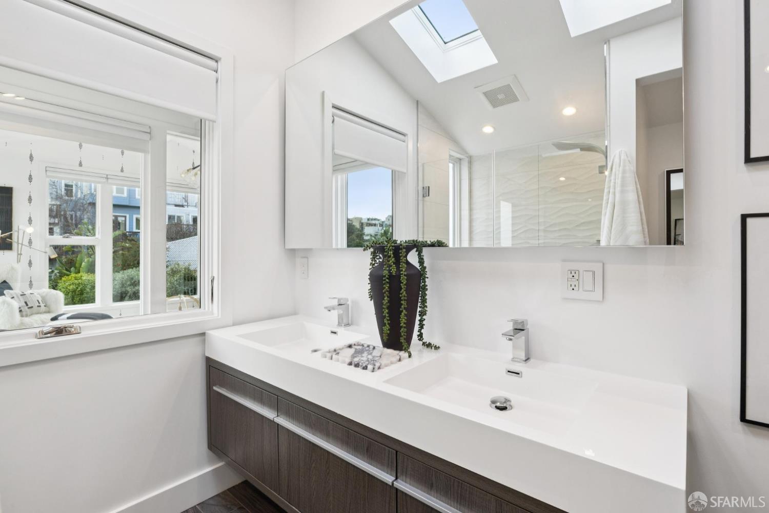 439 Clipper Street San Francisco, CA 94114 - Photo 40 of 71 a bathroom with a sink and a mirror