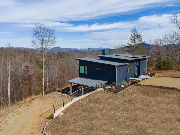 a view of a terrace with a rug and a chandelier