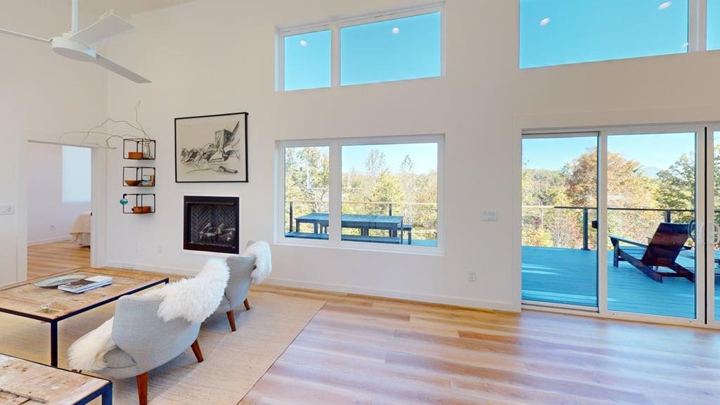 458 Brannon Ridge Young Harris, GA 30582 - Photo 28 of 33 a living room with furniture a fireplace and a floor to ceiling window