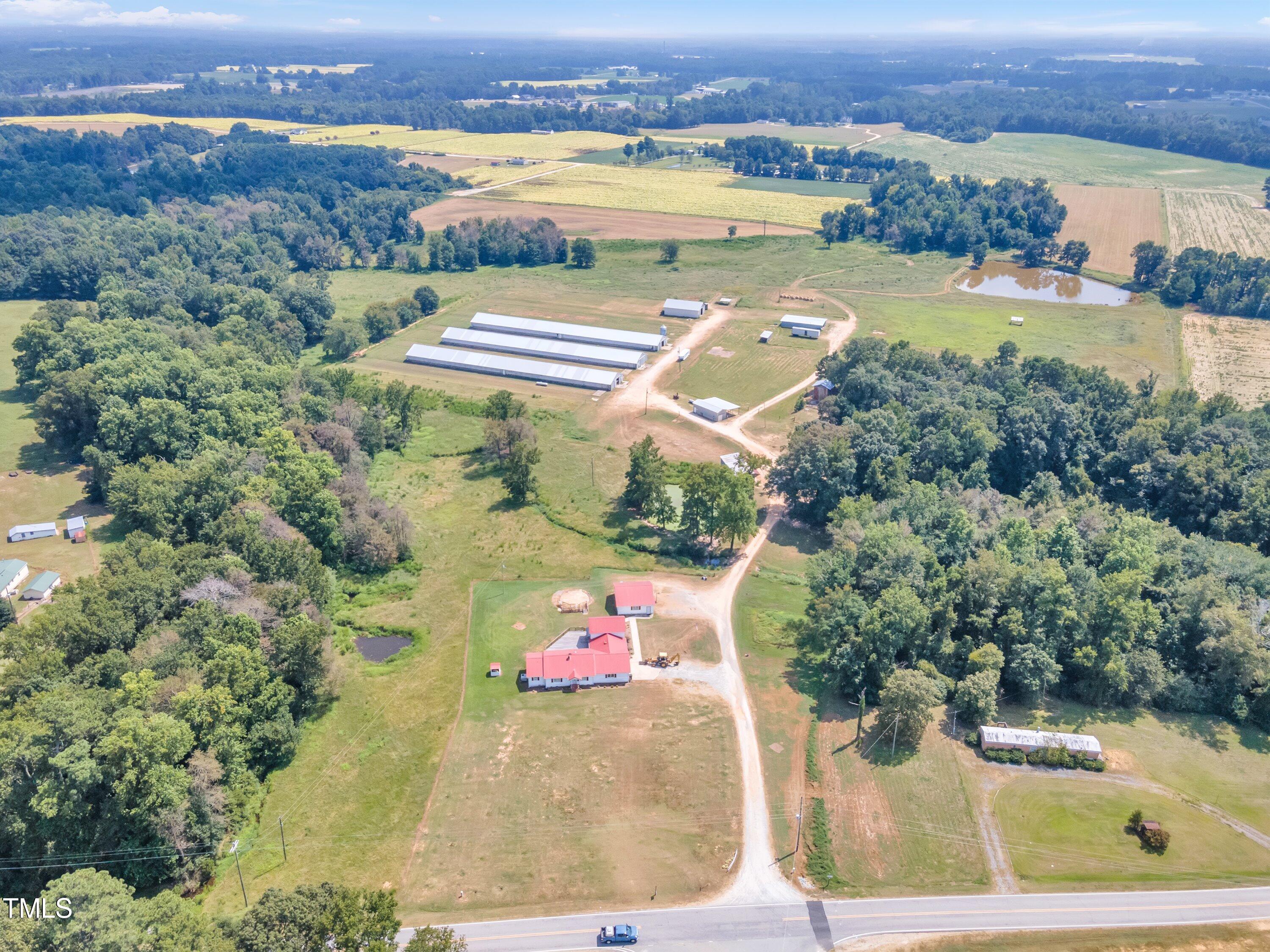 8585 Stricklands Crossroads Road Four Oaks, NC 27524 - Photo 2 of 30 an aerial view of a house with a lake view