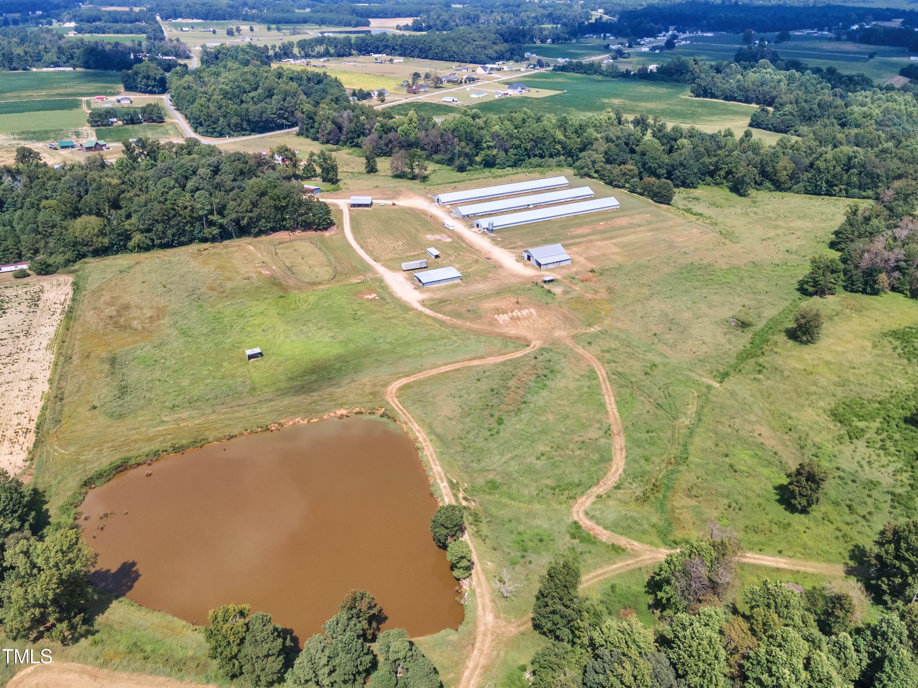 8585 Stricklands Crossroads Road Four Oaks, NC 27524 - Photo 6 of 30 an aerial view of a house with a yard and lake view