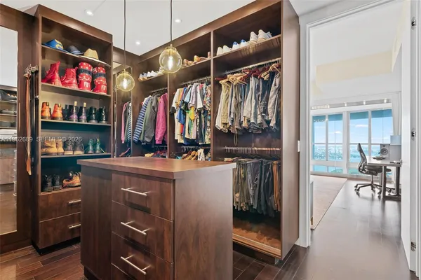 a large bathroom with a double vanity sink a mirror and a bathtub