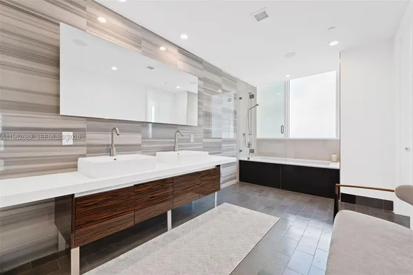 a bathroom with a sink double vanity and a mirror