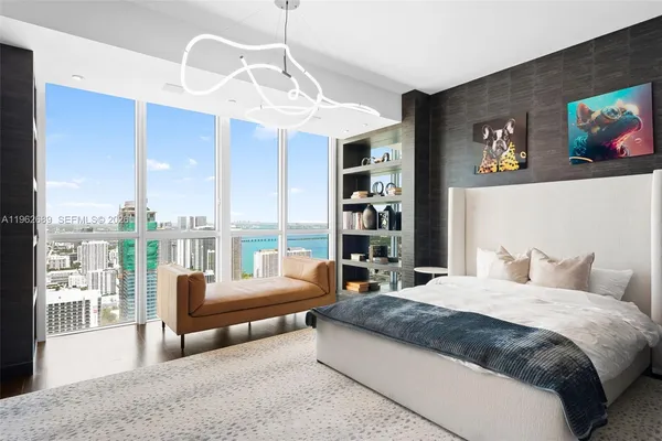 a spacious bedroom with a large bed and a large mirror