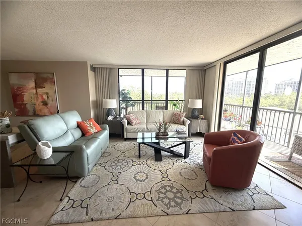 a living room with furniture and a dining table