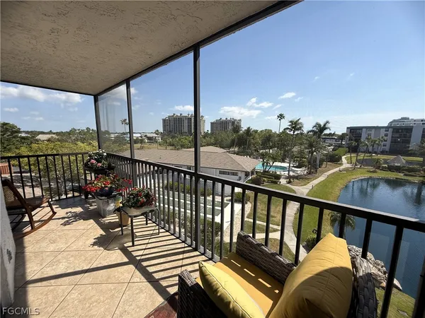 an outdoor view from a balcony with seating space