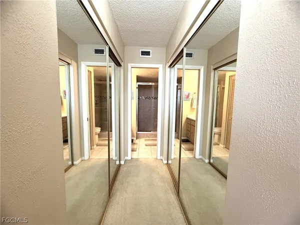 a bedroom with a bed and a couch next to a window