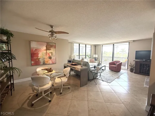 a dining room with furniture and a window