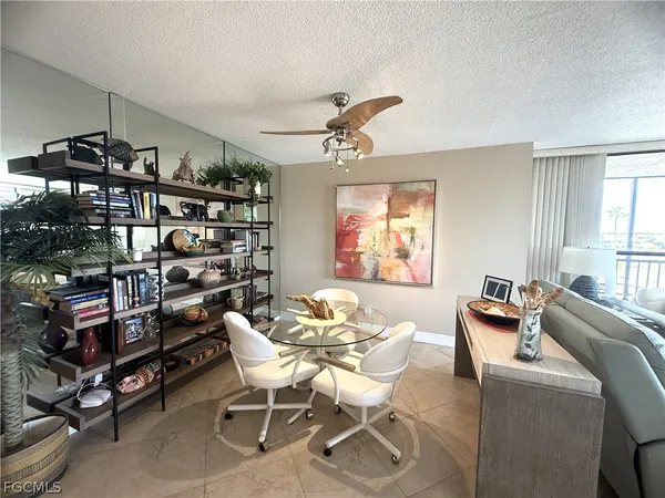 a living room with furniture a flat screen tv and a table
