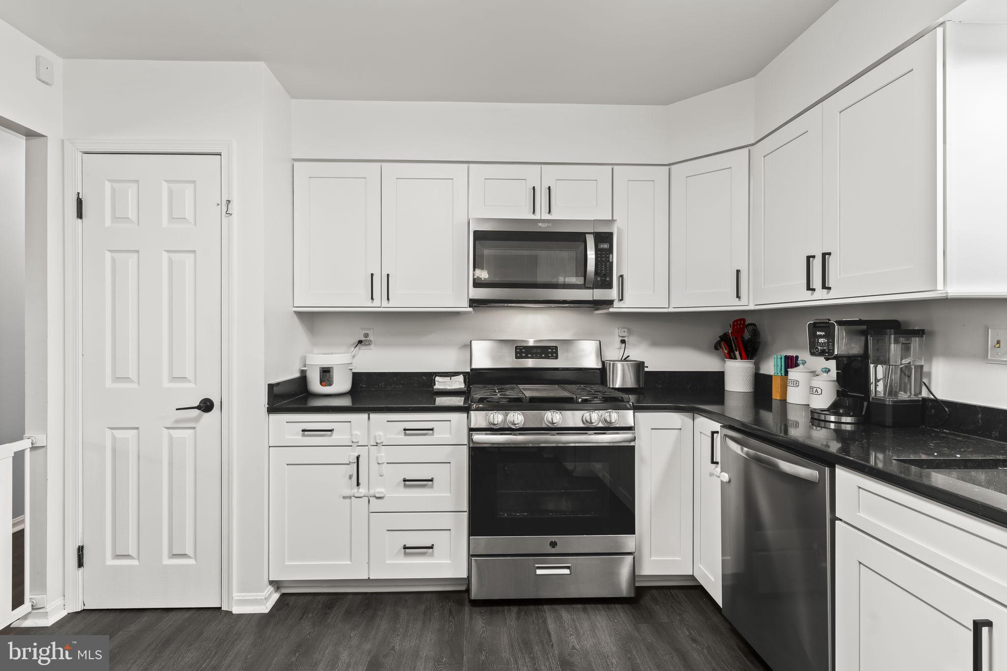 7407 Bellefield Avenue Fort Washington, MD 20744 - Photo 11 of 34 a kitchen with stainless steel appliances granite countertop grey cabinets a stove a sink and dishwasher