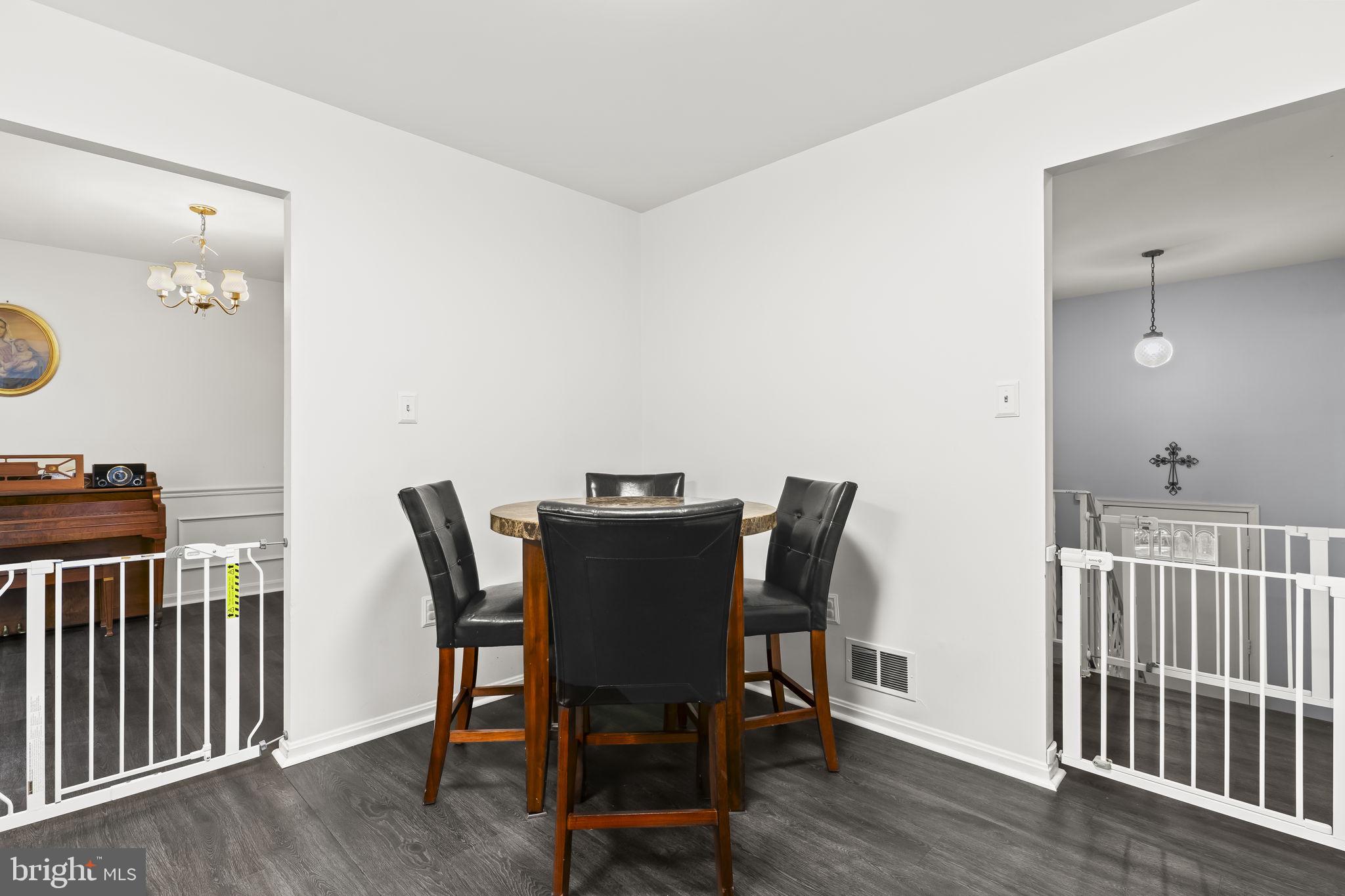 7407 Bellefield Avenue Fort Washington, MD 20744 - Photo 12 of 34 a view of a dining room with furniture and wooden floor