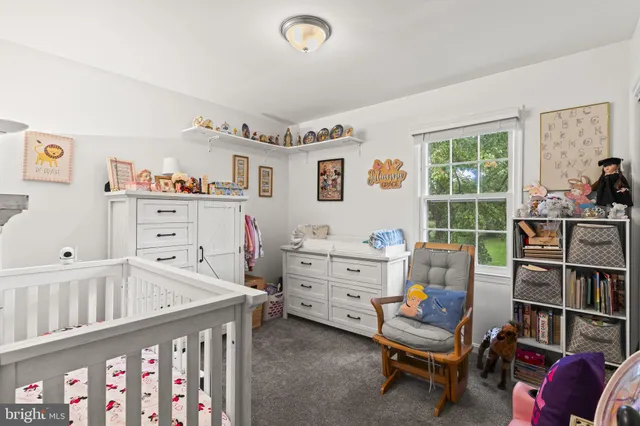 a room with furniture a baby crib and a window