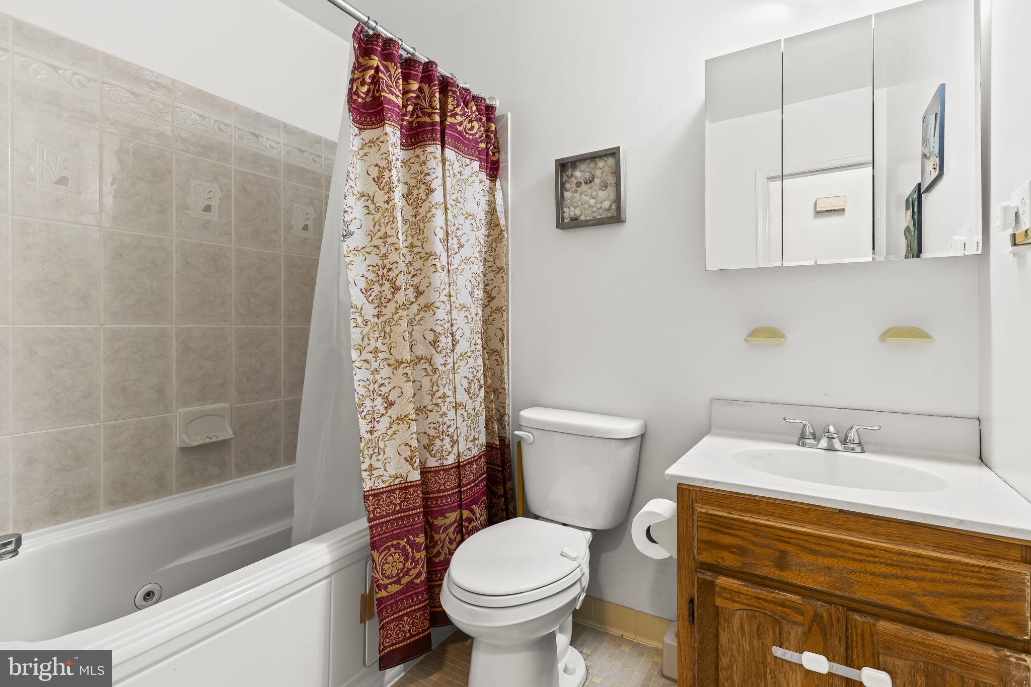 7407 Bellefield Avenue Fort Washington, MD 20744 - Photo 17 of 34 a bathroom with a sink toilet and shower