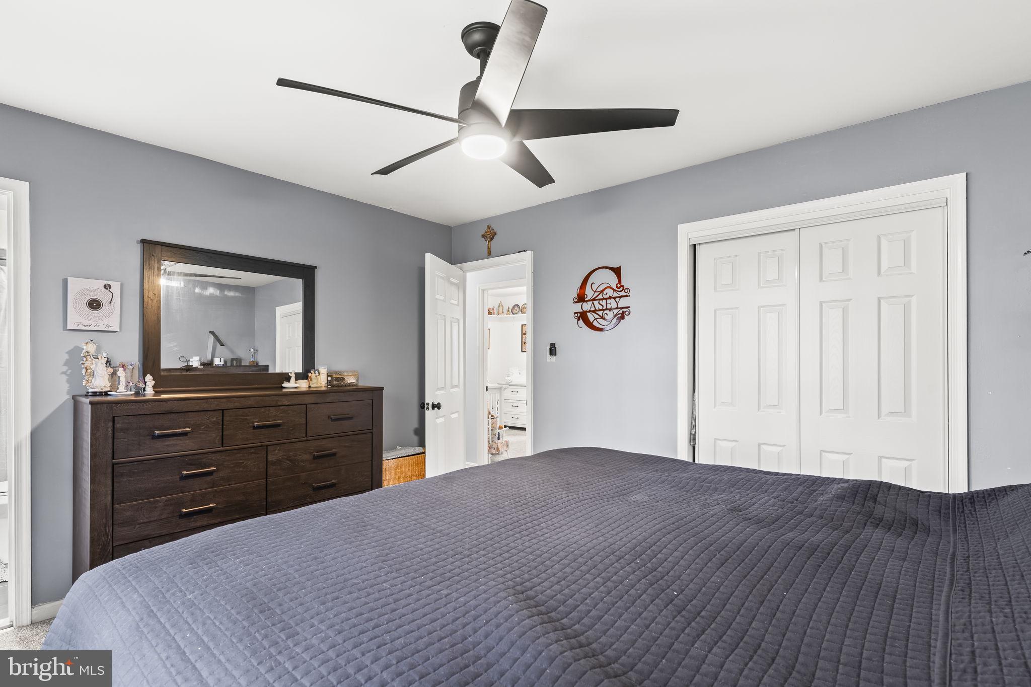 7407 Bellefield Avenue Fort Washington, MD 20744 - Photo 19 of 34 a bedroom with a bed and a mirror on the dresser