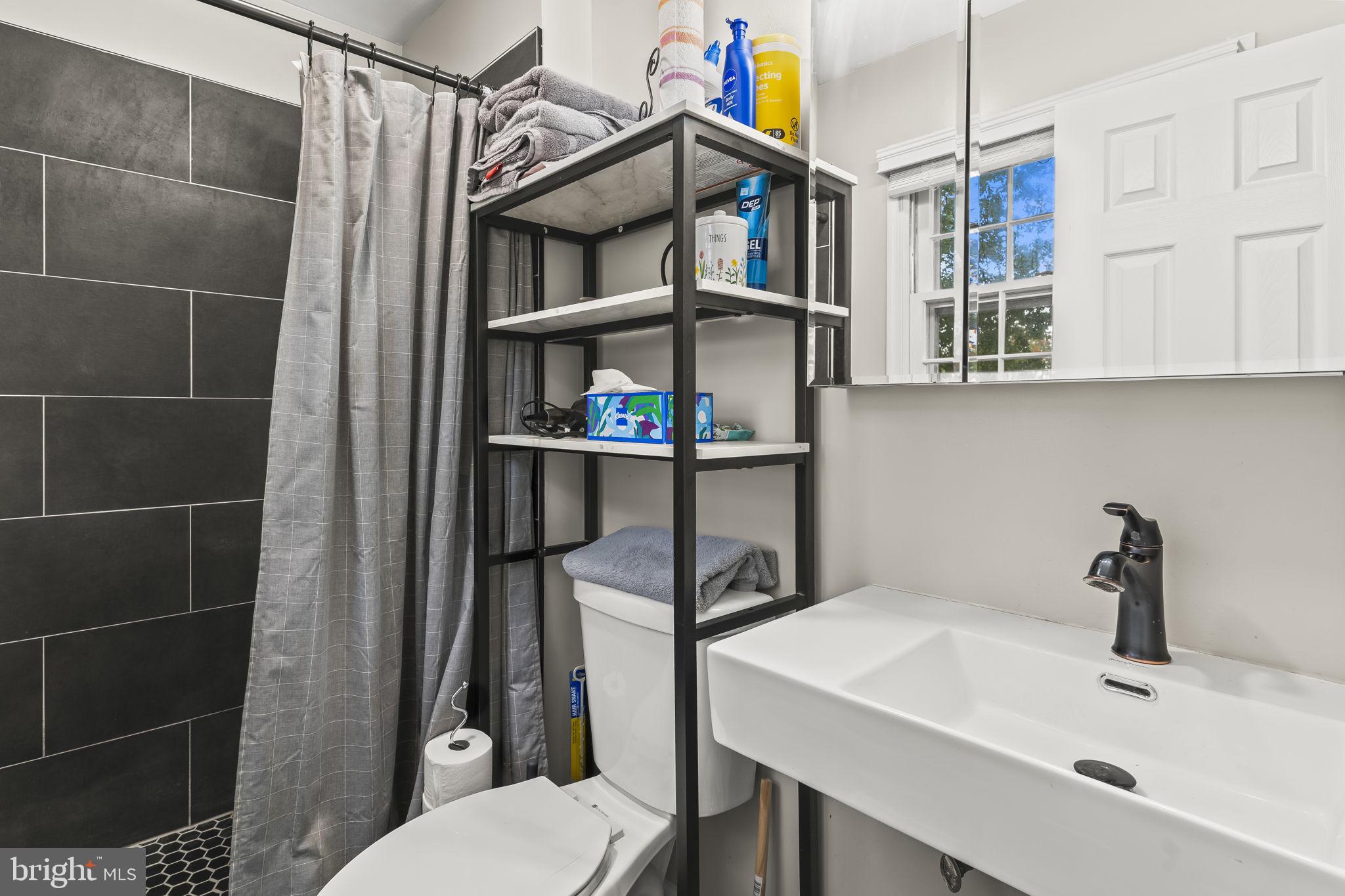 7407 Bellefield Avenue Fort Washington, MD 20744 - Photo 20 of 34 a bathroom with a sink toilet and a shower
