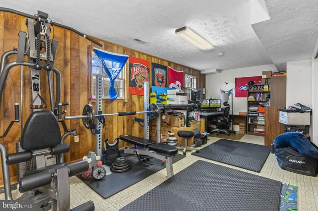 a room with gym equipment and lots of equipment