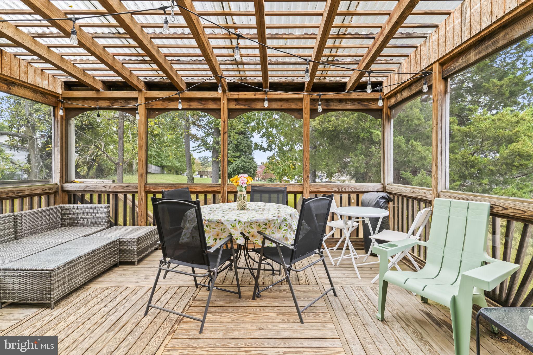 7407 Bellefield Avenue Fort Washington, MD 20744 - Photo 29 of 34 a view of a patio with lawn chairs and wooden floor