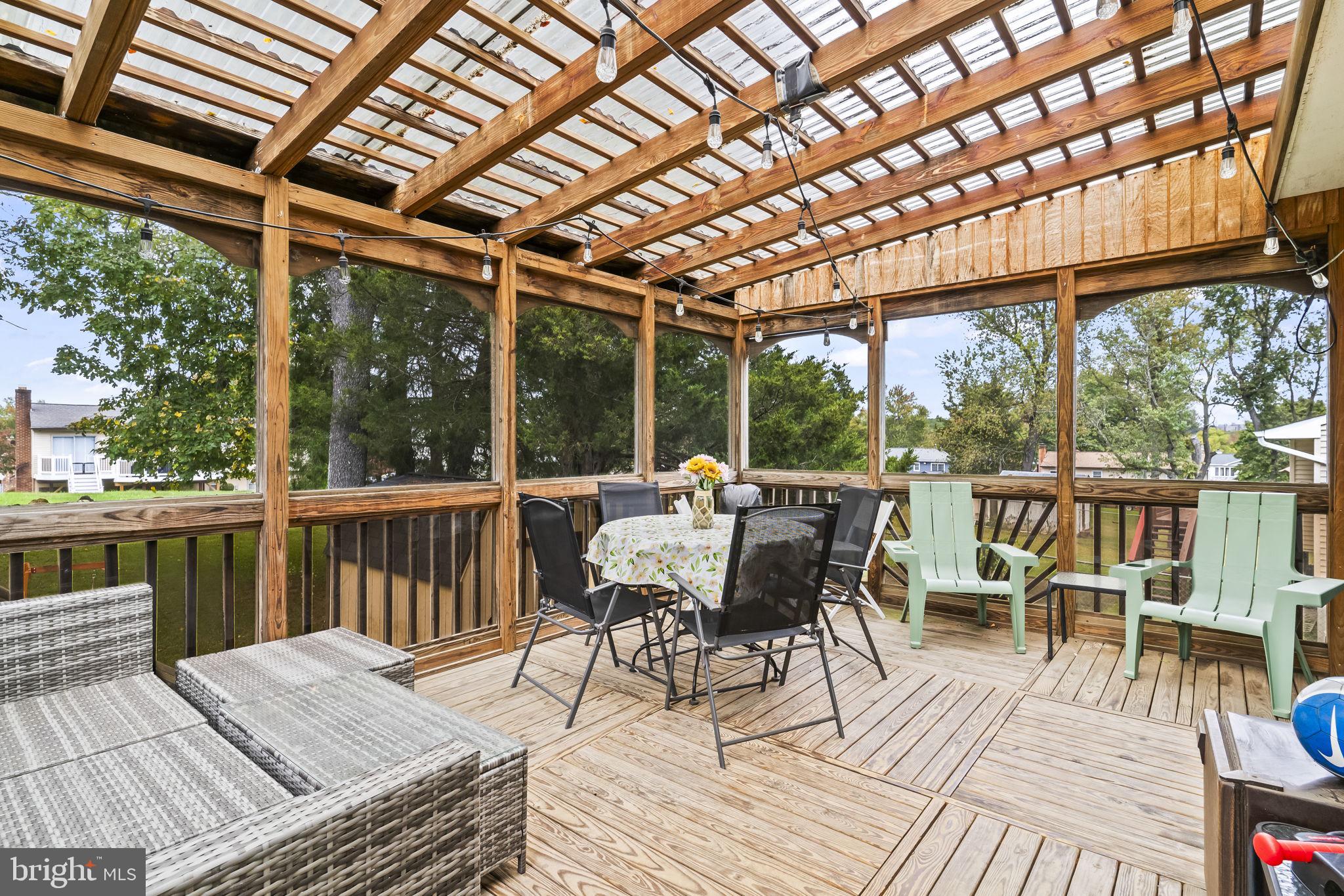 7407 Bellefield Avenue Fort Washington, MD 20744 - Photo 30 of 34 a view of a dining room with wooden floor outdoor seating and yard in the back