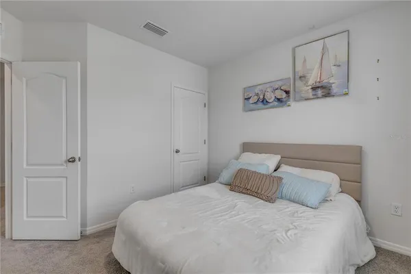 a bedroom with a bed and wall painting