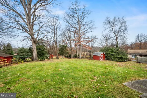 a view of a tree in front of a house