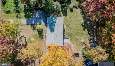 a aerial view of a house with a yard basket ball court and outdoor seating