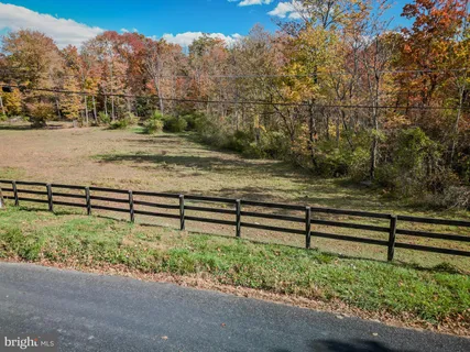 a view of a yard with wooden fence