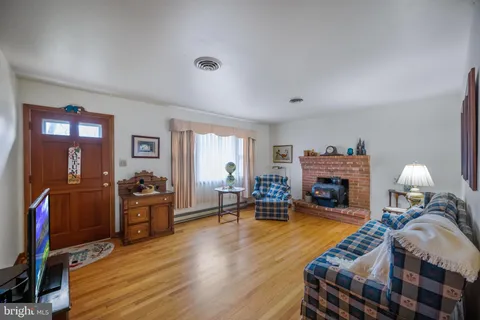 a living room with furniture fireplace and a table
