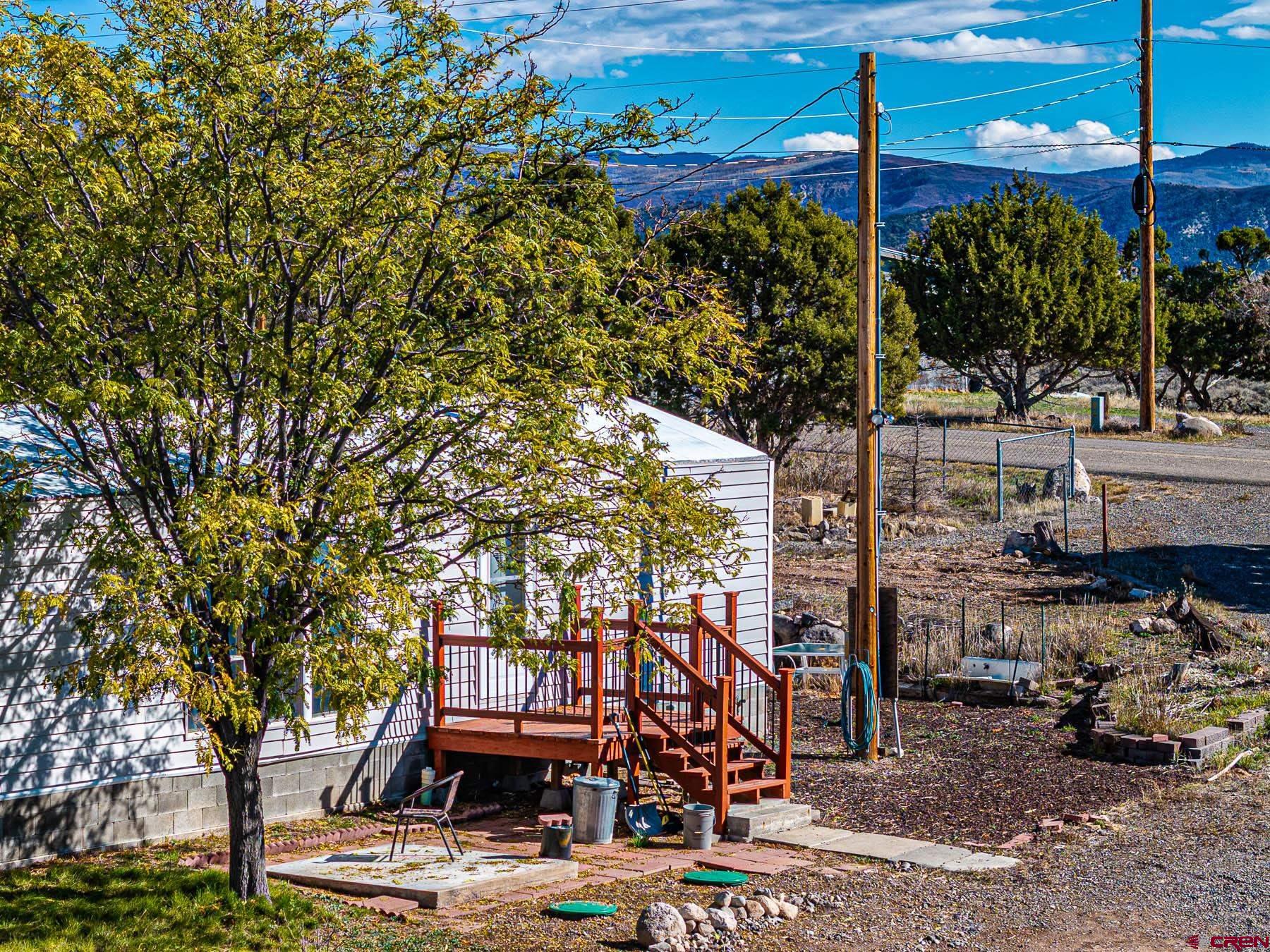 17199 2550th Road Cedaredge, CO 81413 - Photo 4 of 38 a view of a patio with table and chairs and potted plants