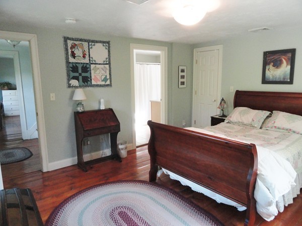 61 Coldbrook Road Oakham, MA 01068 - Photo 14 of 30 a bedroom with a bed a dresser and next to a window