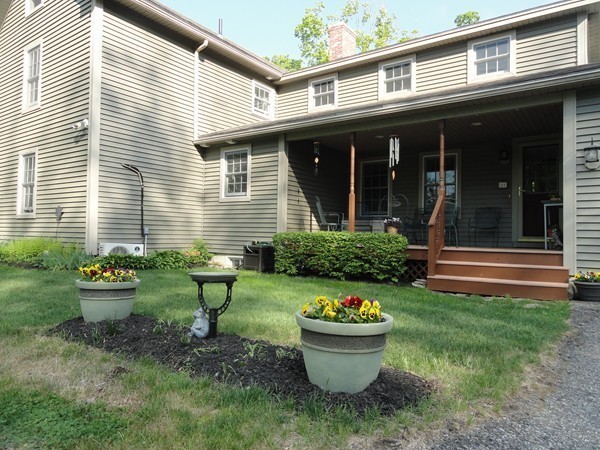 61 Coldbrook Road Oakham, MA 01068 - Photo 27 of 30 a front view of a house with porch and garden
