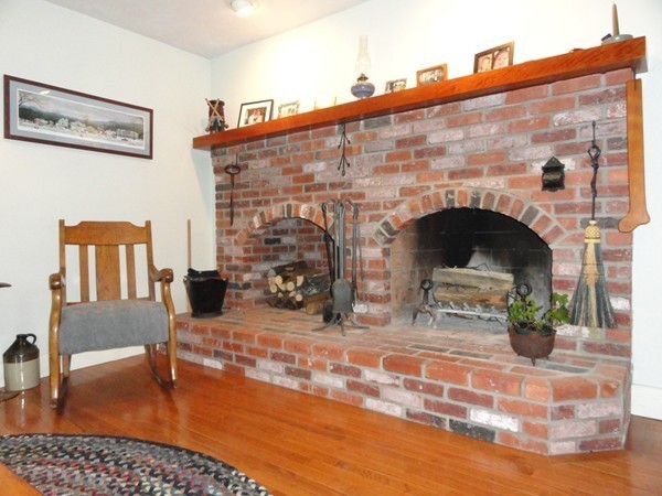 61 Coldbrook Road Oakham, MA 01068 - Photo 5 of 30 a view of empty room with fireplace and wooden floor