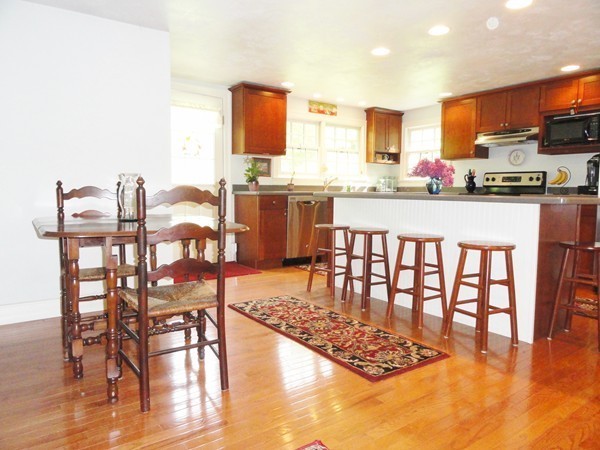 61 Coldbrook Road Oakham, MA 01068 - Photo 8 of 30 a kitchen with stainless steel appliances kitchen island granite countertop a table chairs and a refrigerator