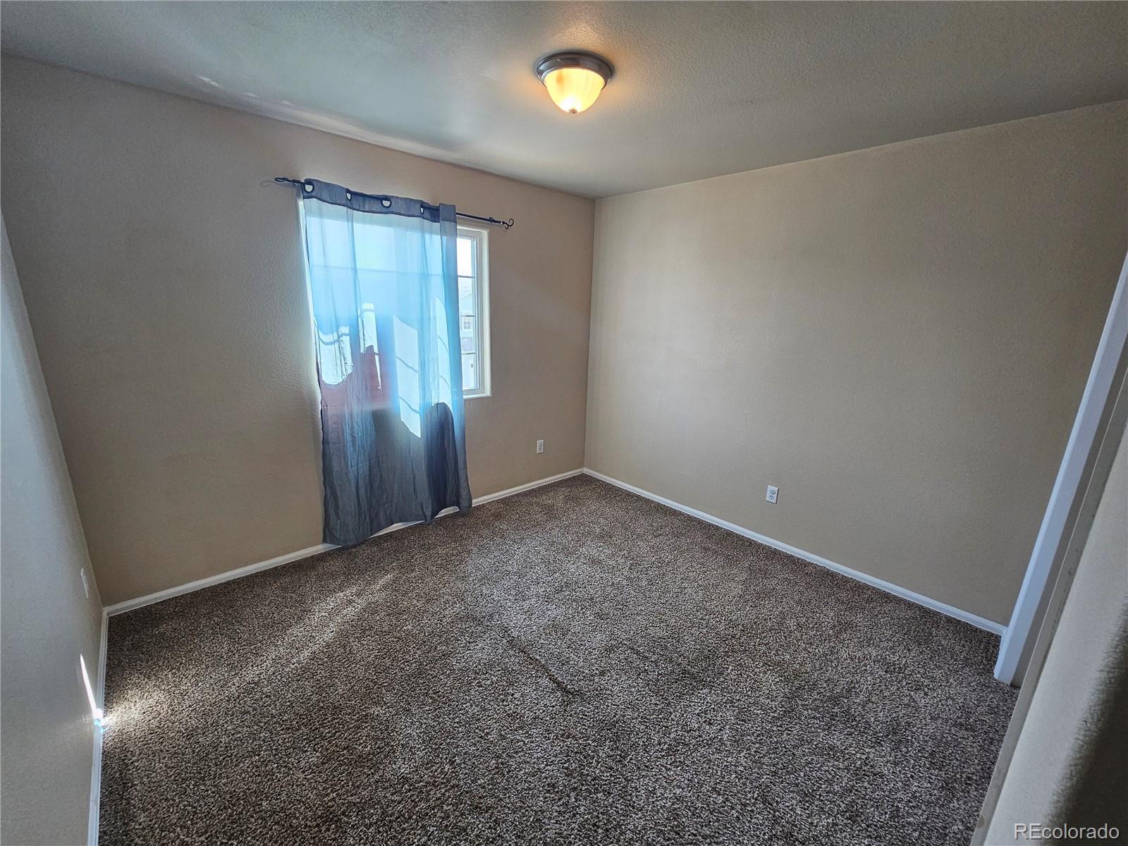 5352 Canadian Rose View Colorado Springs, CO 80916 - Photo 10 of 16 an empty room with windows and closet