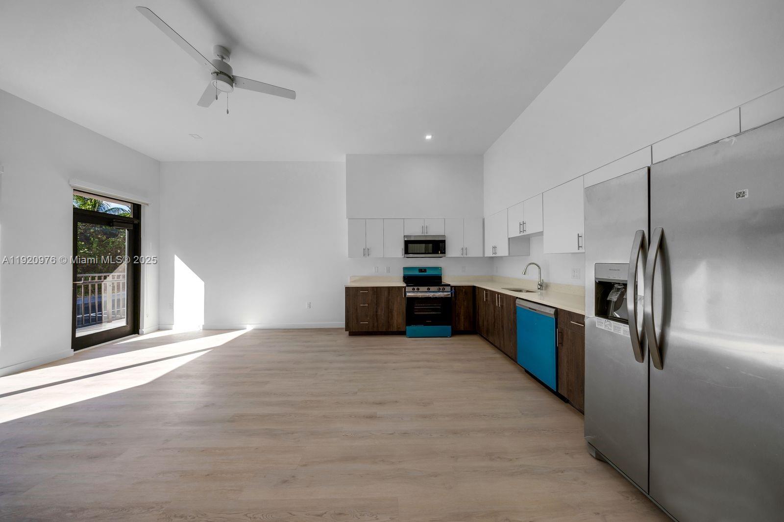 20 Northeast 19th Avenue, Unit 101 Pompano Beach, FL 33060 - Photo 3 of 17 a large kitchen with stainless steel appliances kitchen island a large counter top and a refrigerator