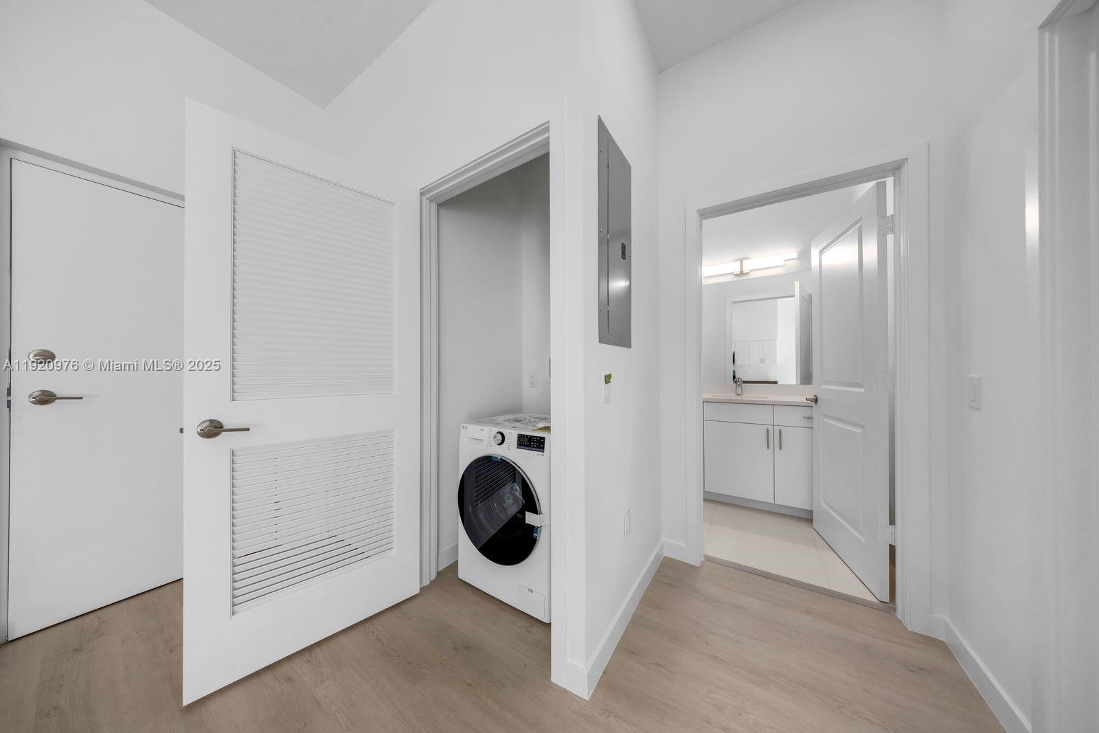 20 Northeast 19th Avenue, Unit 101 Pompano Beach, FL 33060 - Photo 4 of 17 a view of a bathroom with a sink and mirror