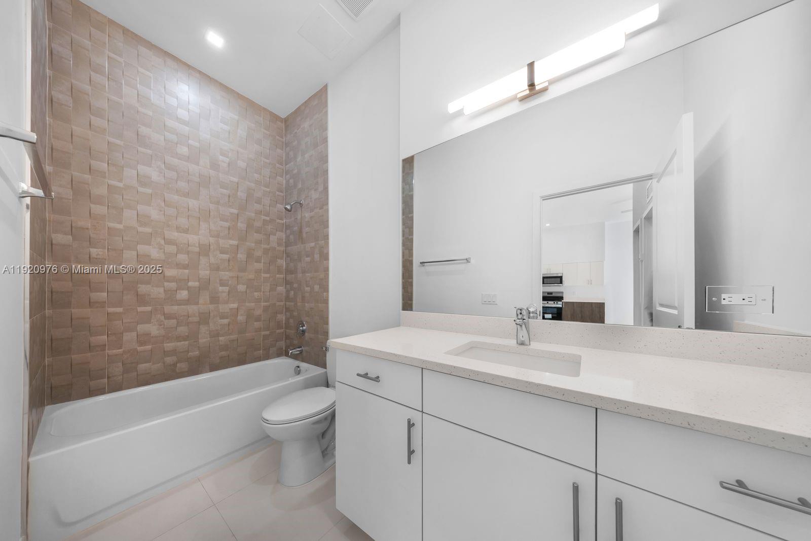 20 Northeast 19th Avenue, Unit 101 Pompano Beach, FL 33060 - Photo 6 of 17 a bathroom with a sink a toilet and shower