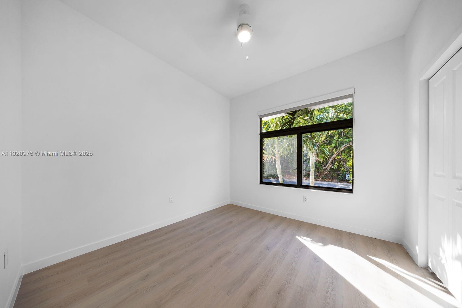 20 Northeast 19th Avenue, Unit 101 Pompano Beach, FL 33060 - Photo 7 of 17 an empty room with windows