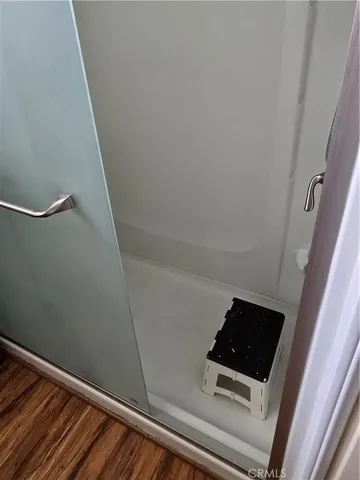 a room with a wooden floor and white walls