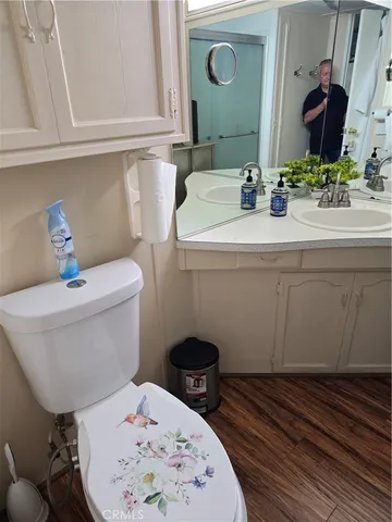 a bathroom with a toilet a sink and a mirror