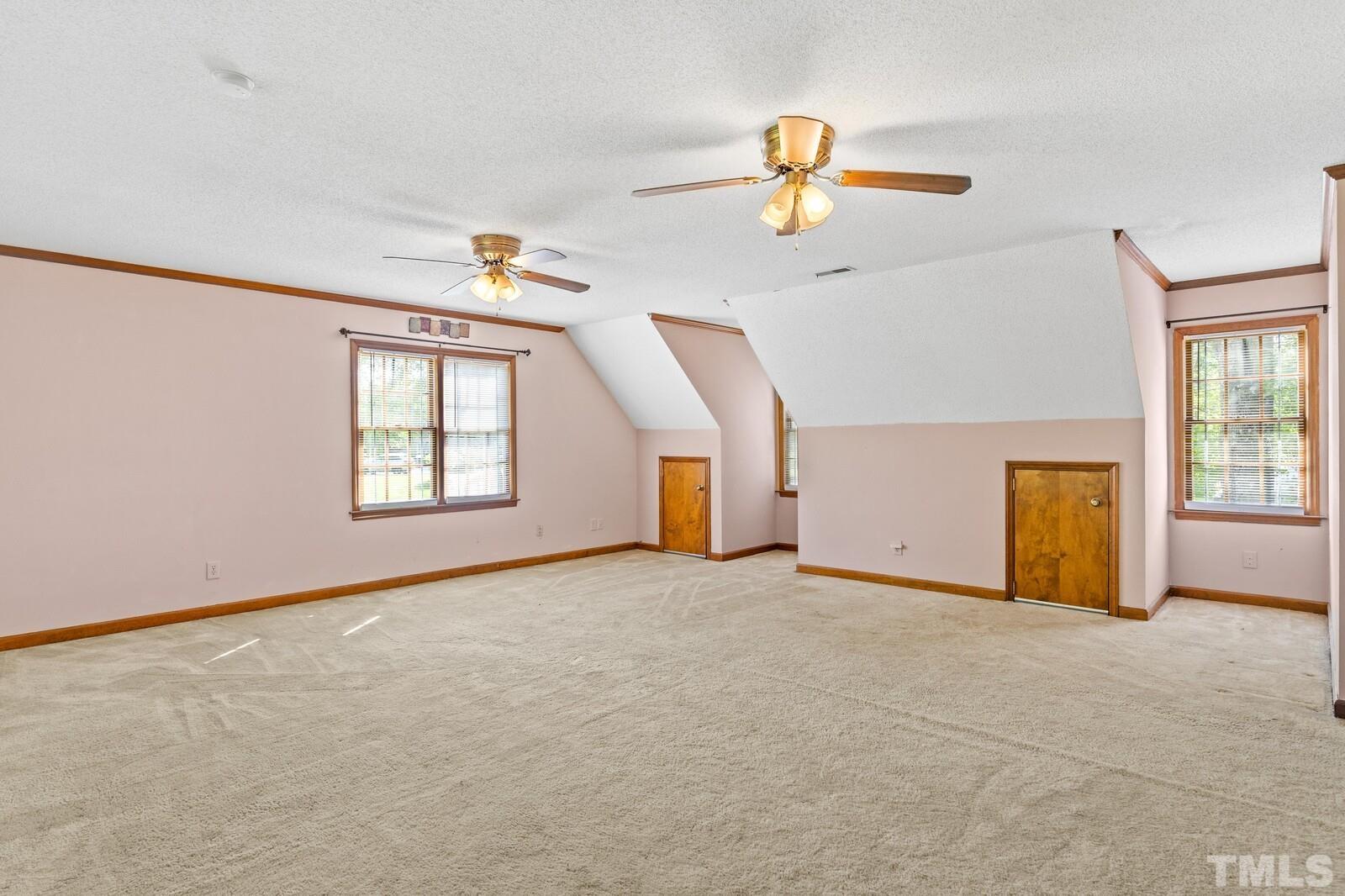 7201 Halstead Lane Raleigh, NC 27613 - Photo 25 of 38 an empty room with windows and ceiling fan