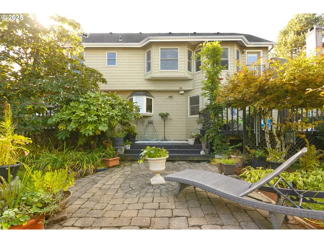 a view of a house with backyard and sitting area
