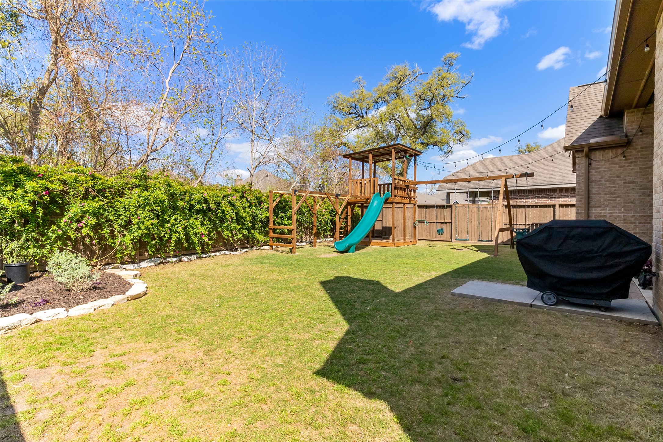 208 Woodside Court Clute, TX 77531 - Photo 25 of 38 a view of a backyard with plants and a fountain