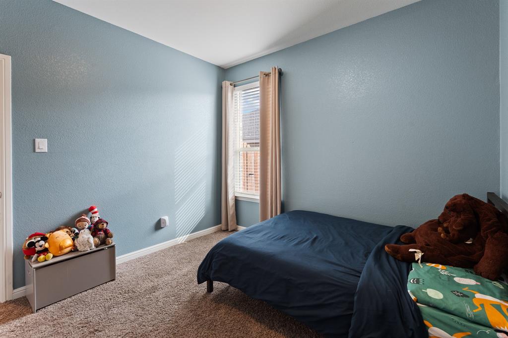 1812 Millbrae Road Cleburne, TX 76033 - Photo 18 of 30 Textured walls in a light blue finish, carpeted flooring, and a window with blinds