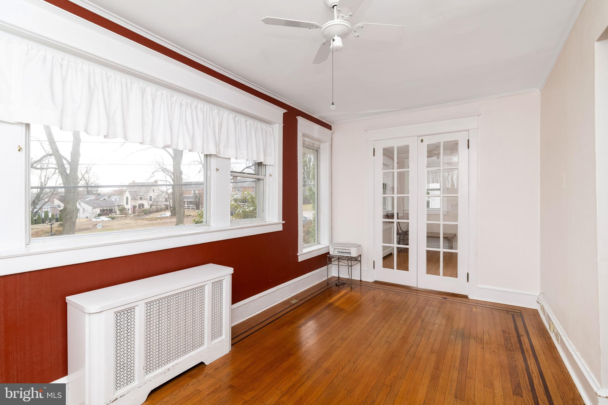 150 Hart Lane Springfield, PA 19064 - Photo 12 of 49 an empty room with wooden floor fan and windows