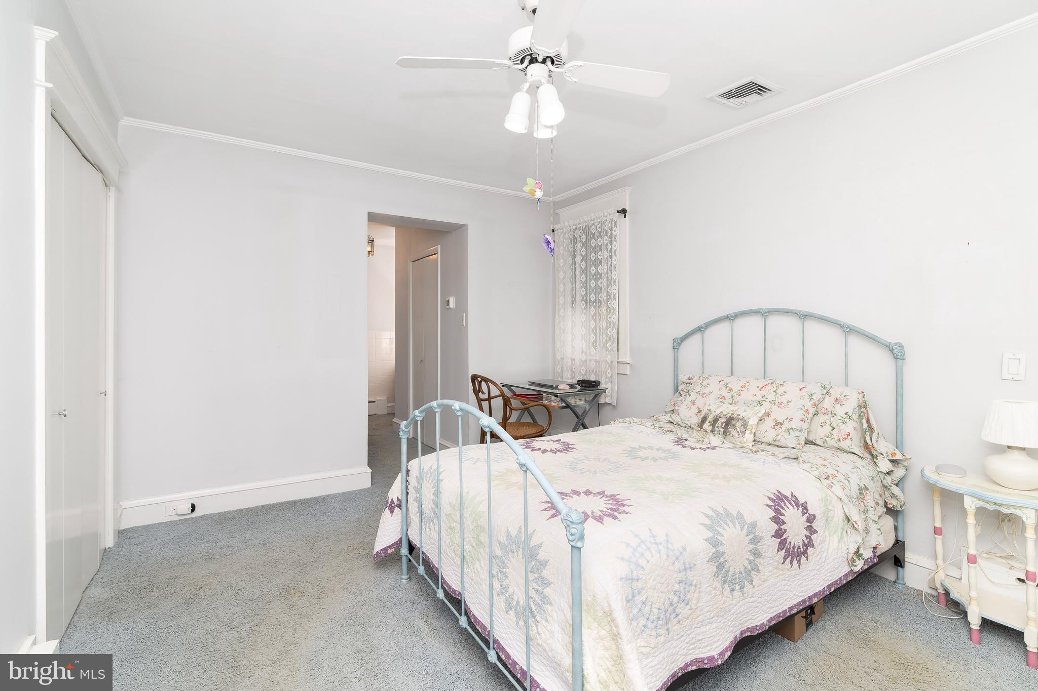 150 Hart Lane Springfield, PA 19064 - Photo 23 of 49 a bedroom with a bed and a chandelier