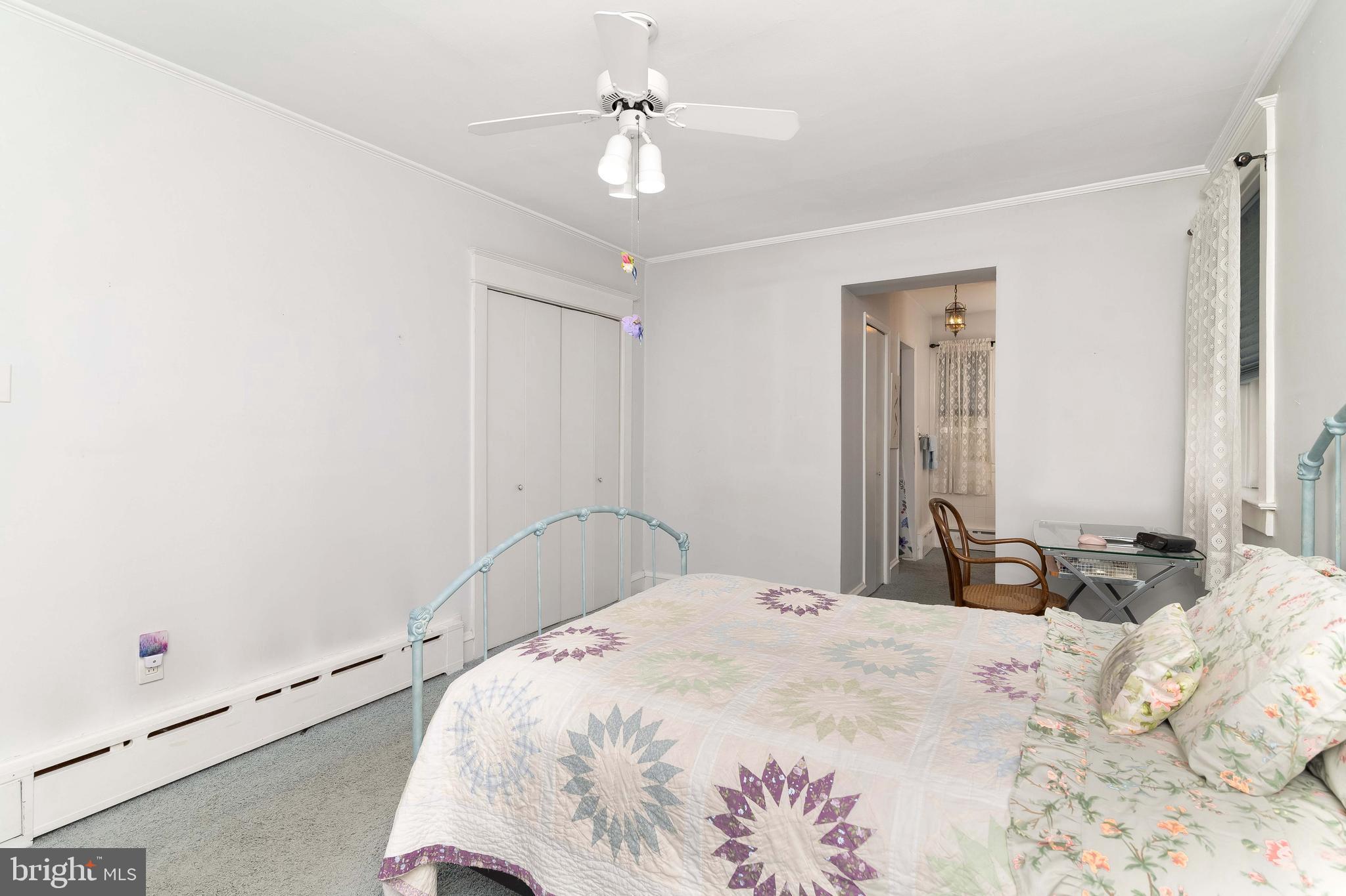 150 Hart Lane Springfield, PA 19064 - Photo 24 of 49 a bedroom with a bed and a chandelier