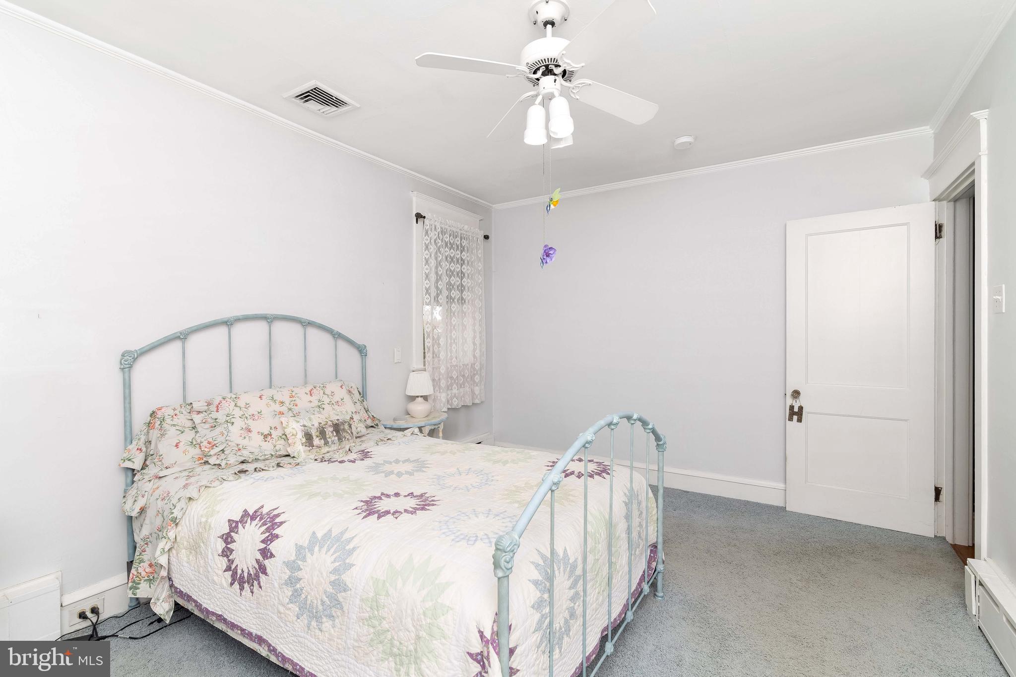 150 Hart Lane Springfield, PA 19064 - Photo 25 of 49 a bedroom with a bed and a chandelier