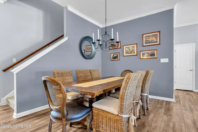 a living room with stainless steel appliances granite countertop furniture a fireplace a flat screen tv and kitchen view